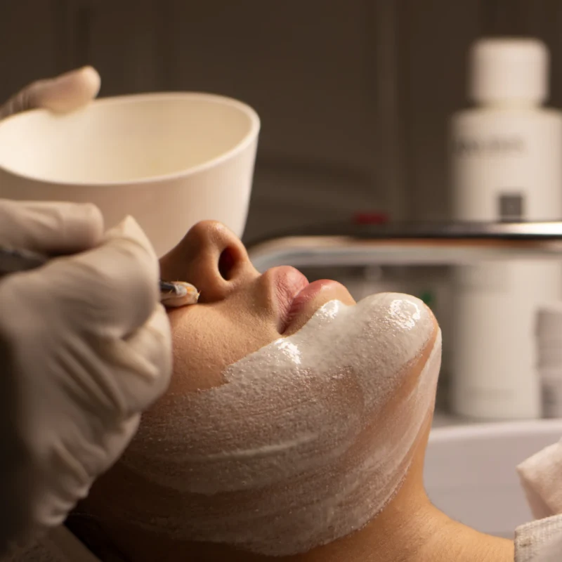 Therapist giving a client a professional deep-cleansing facial